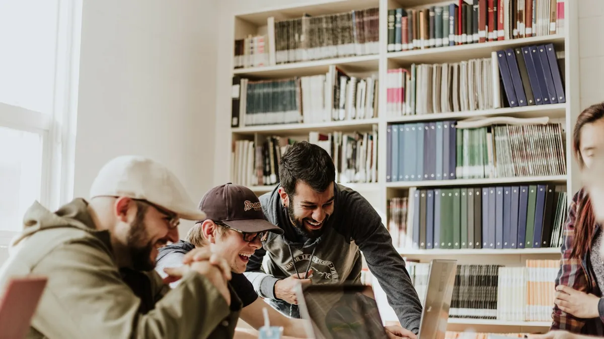 A group working together over laptops in a library